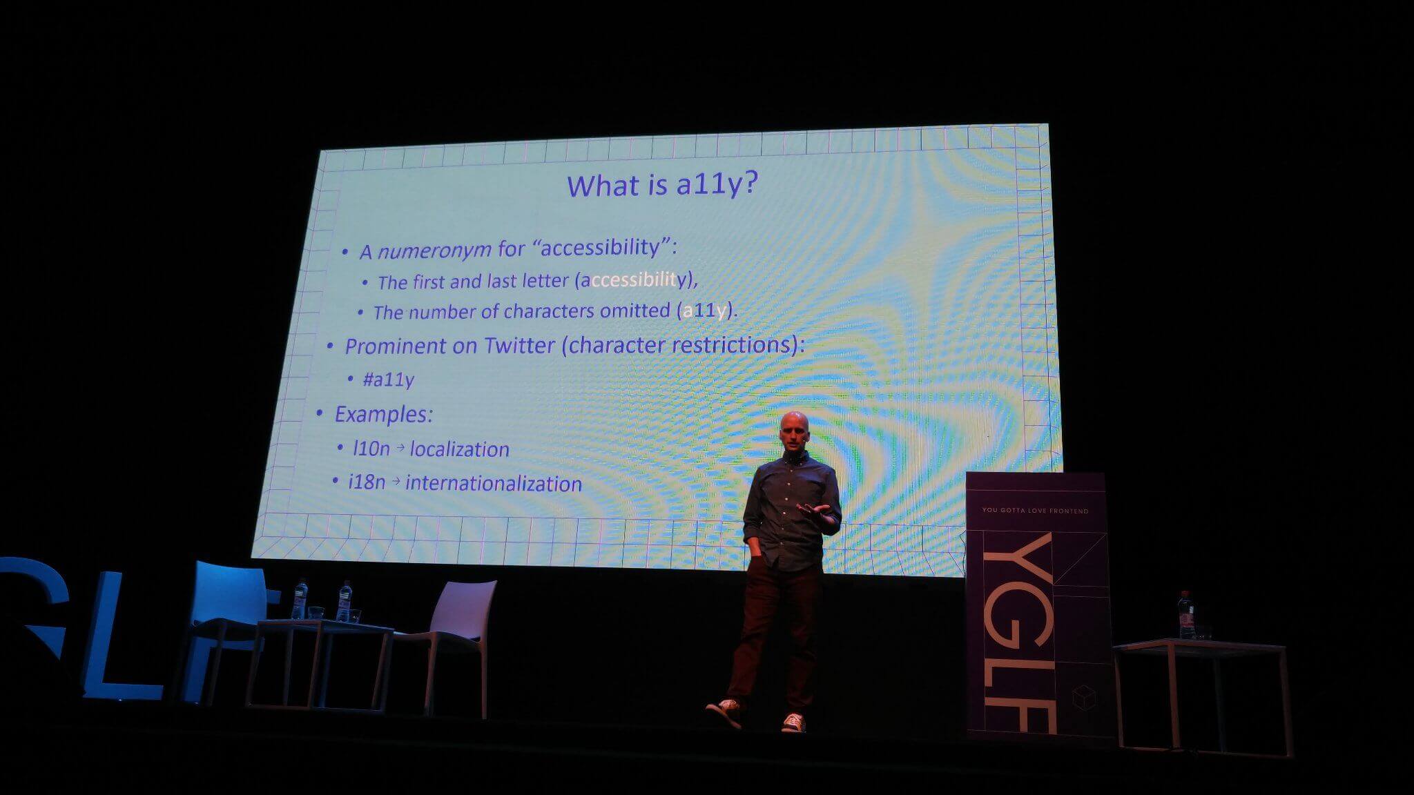 Adrian in front of his numeronym slide.